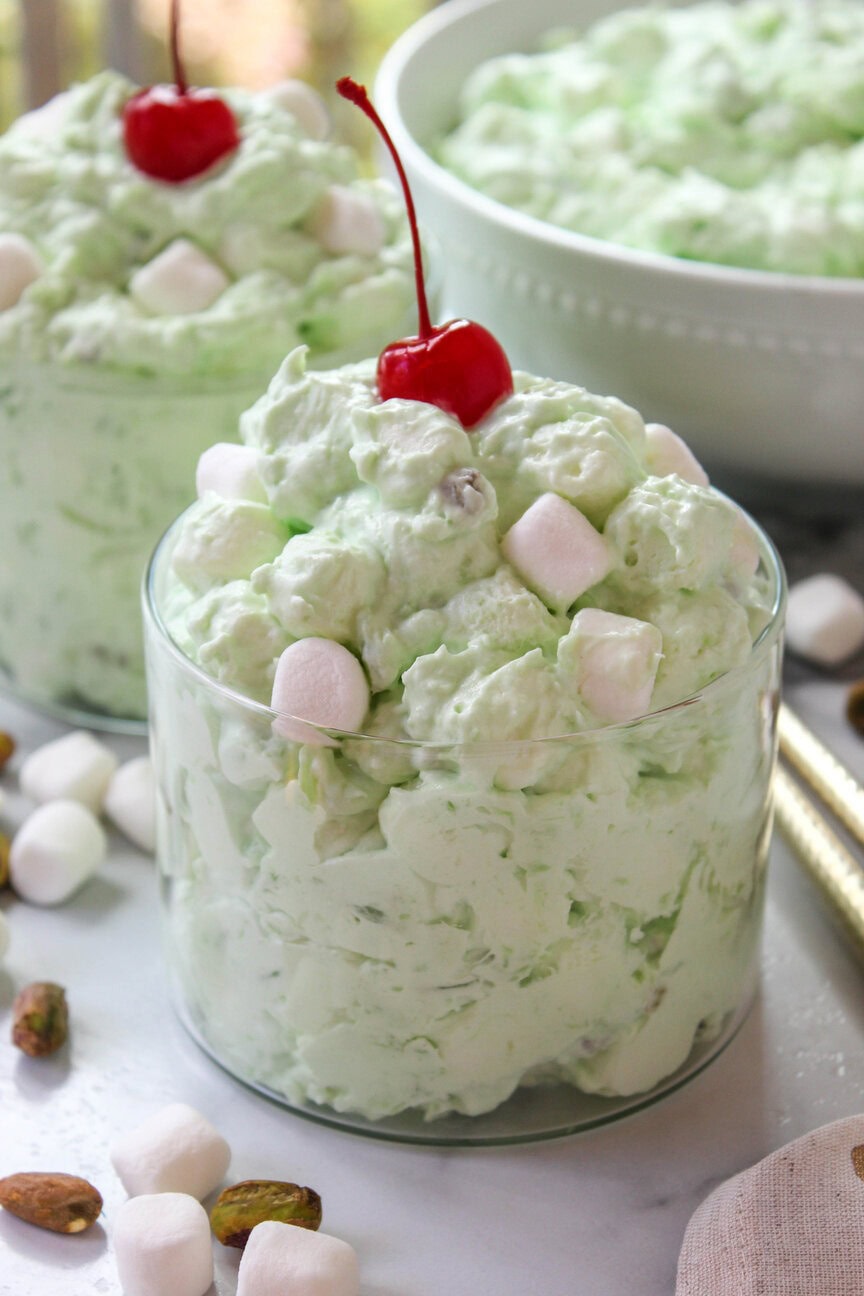 Green pistachio fluff salad with Cool Whip folded in for a light texture