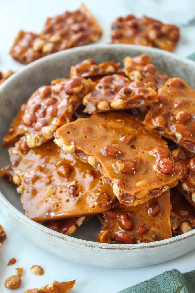 Close‑up of crunchy peanut brittle with roasted peanuts