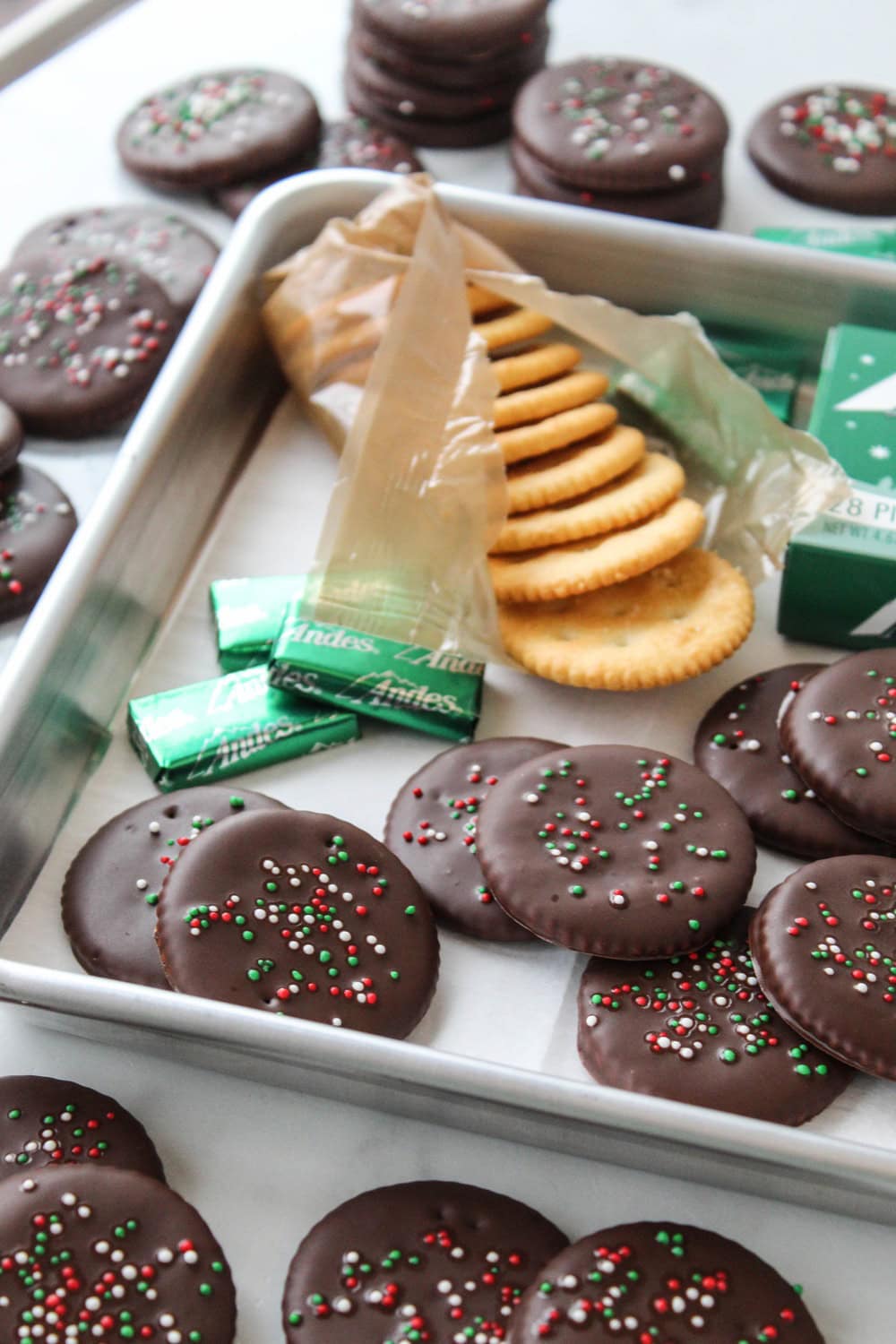 Andes Mint Ritz cookies coated in melted mint chocolate and topped with festive Christmas sprinkles