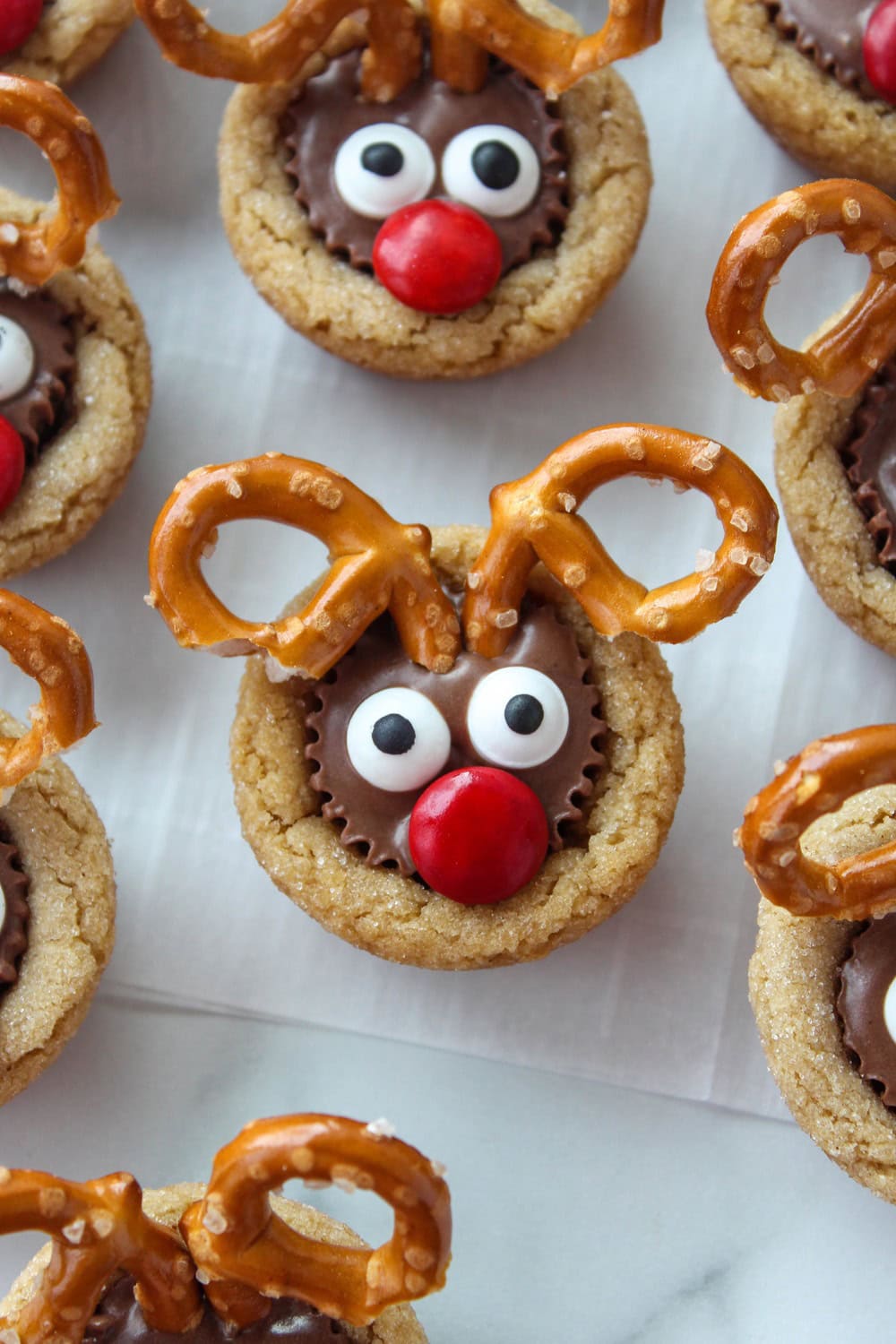 Reindeer cookies with pretzel antlers and bright red M&M noses
