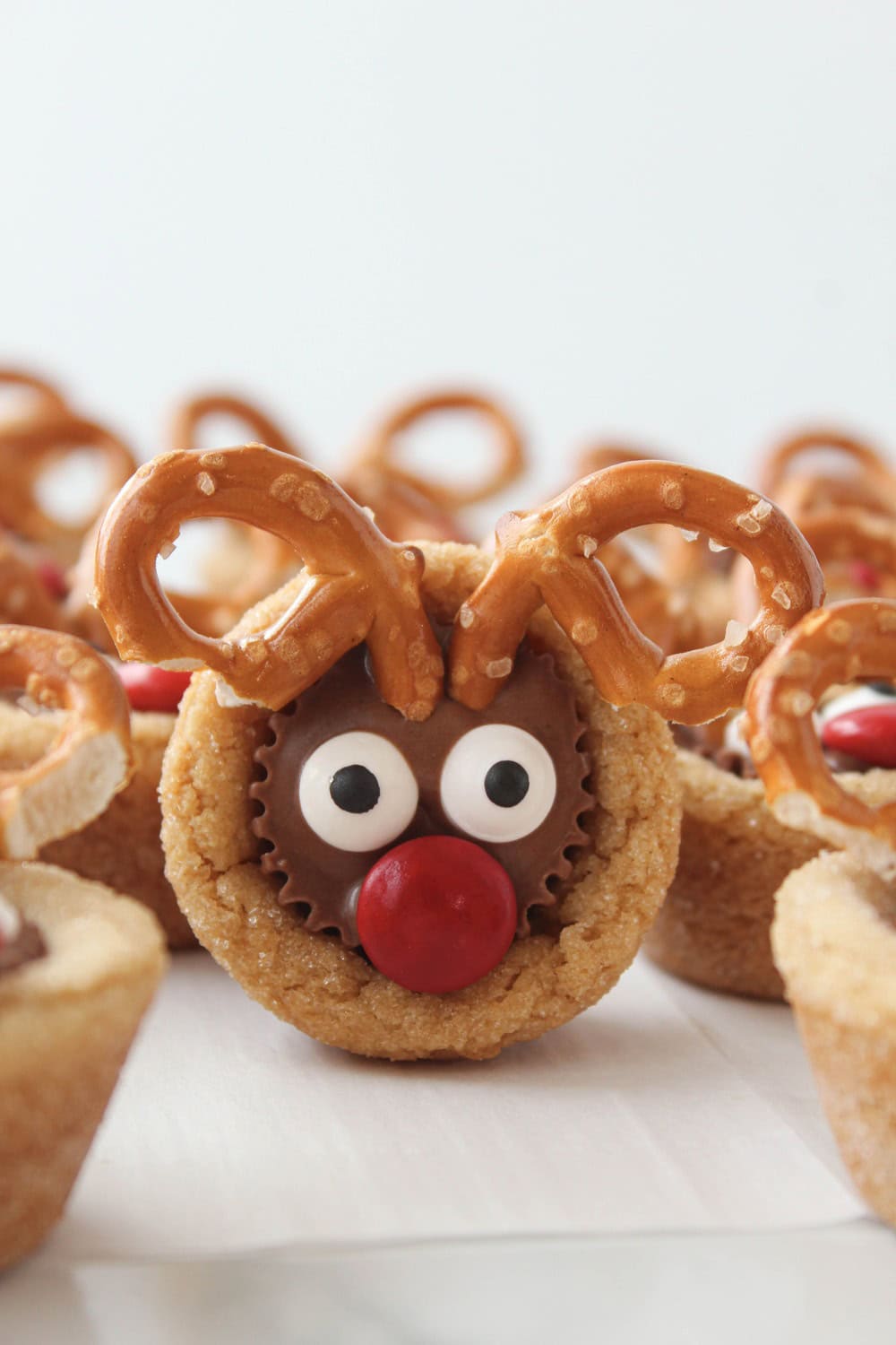 Close‑up of candy eyes and red M&M nose on reindeer cookie