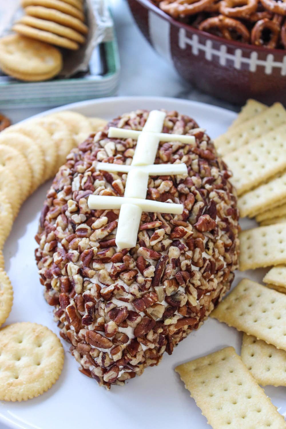Football cheeseball served with crackers