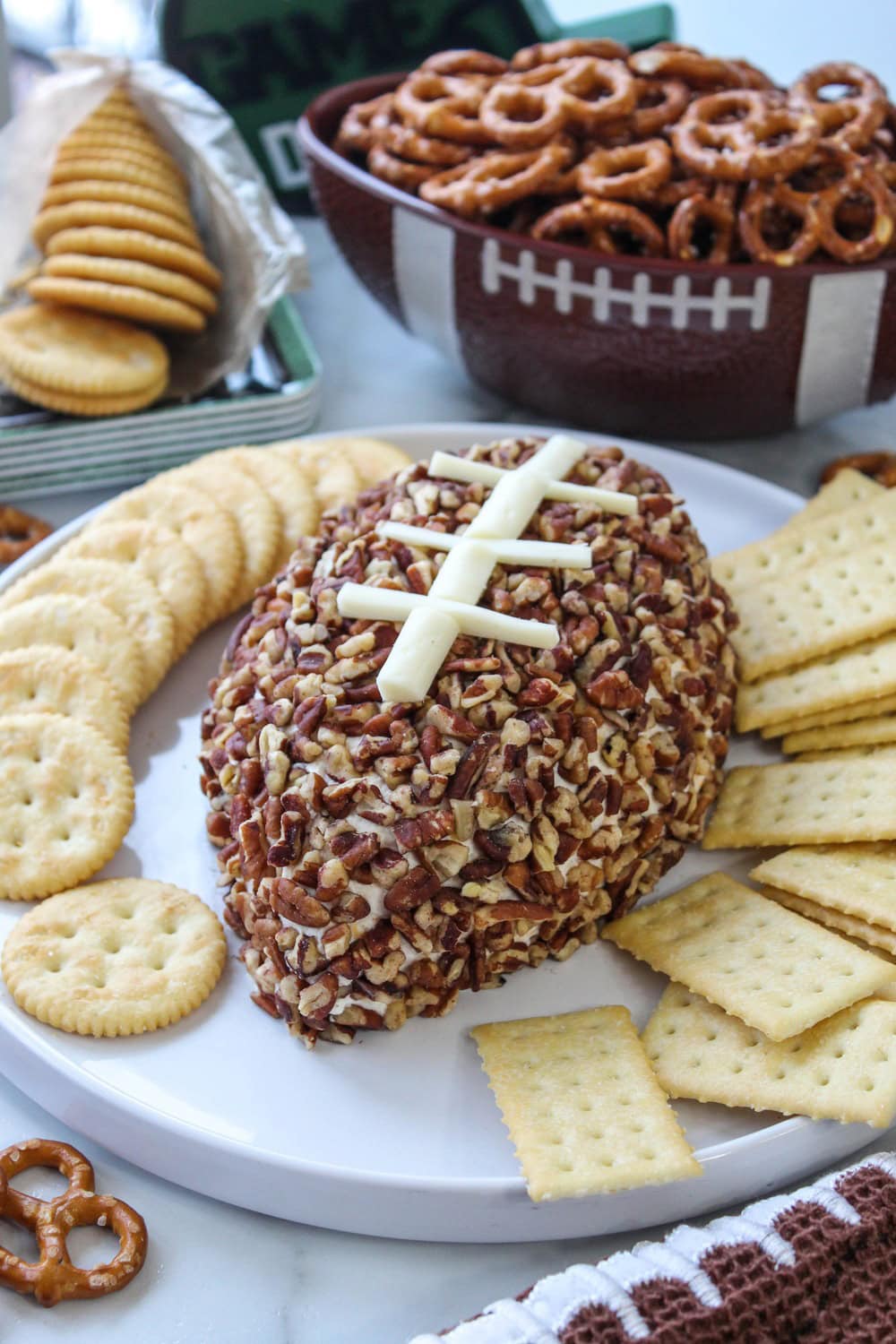Football-shaped cheeseball on a serving platter