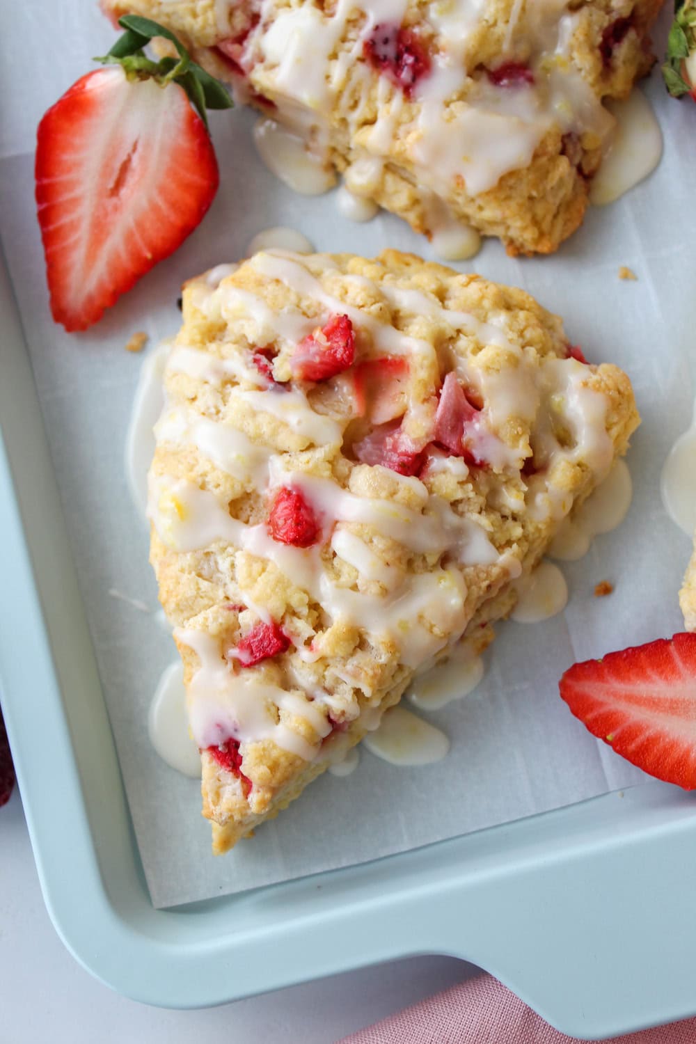 Bakery‑style strawberry lemon scones garnished with lemon zest