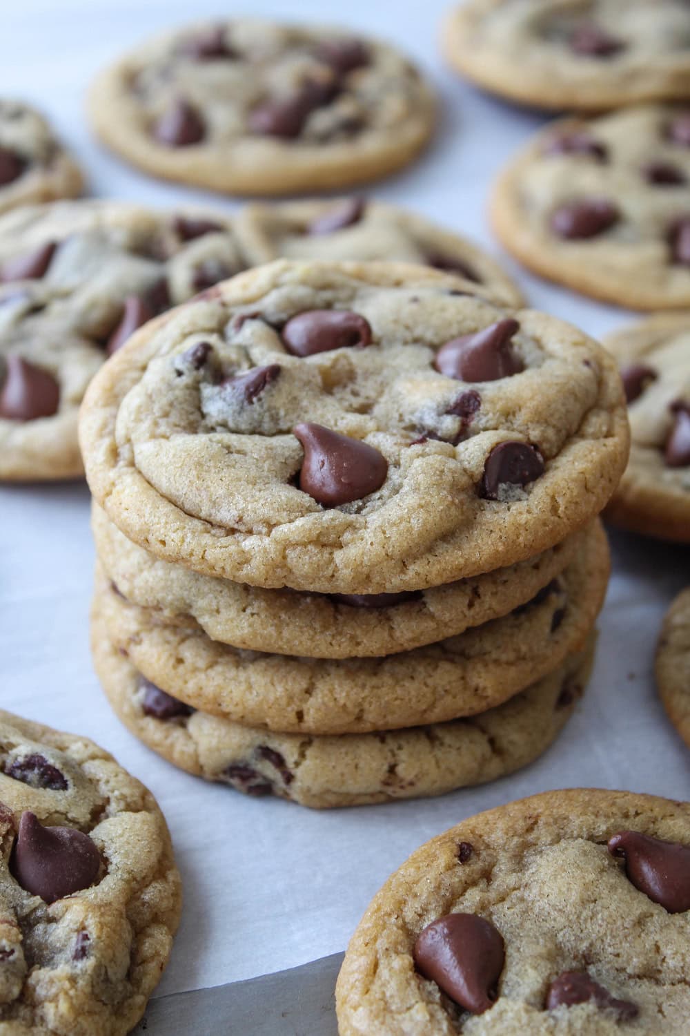 Freshly baked chewy chocolate chip cookies with gooey chocolate and golden edges.