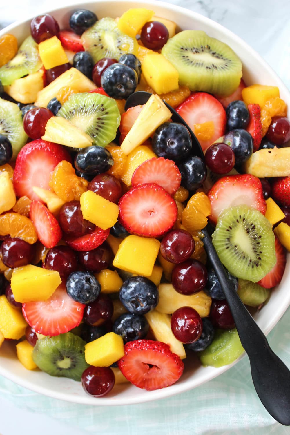 Bright summer fruit salad drizzled with honey lime dressing