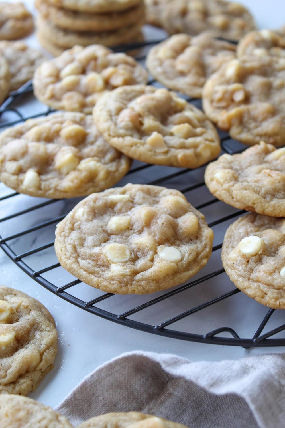 Homemade white chocolate macadamia nut cookies on cooling rack