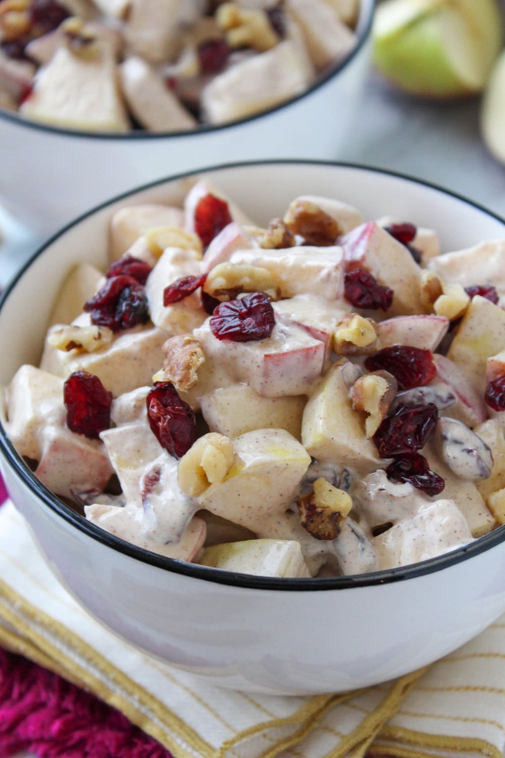 Homemade creamy apple cinnamon salad served in a white bowl