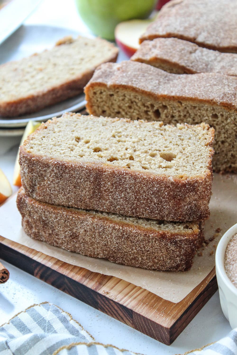 Cinnamon sugar apple cider bread served on a wooden cutting board