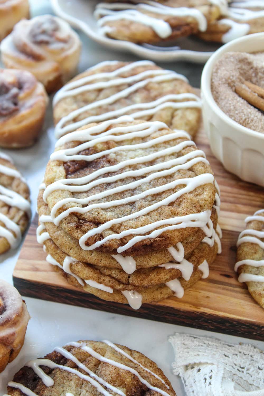 Close-up of fluffy cinnamon roll cookies featuring layers of cinnamon sugar and a creamy icing drizzle