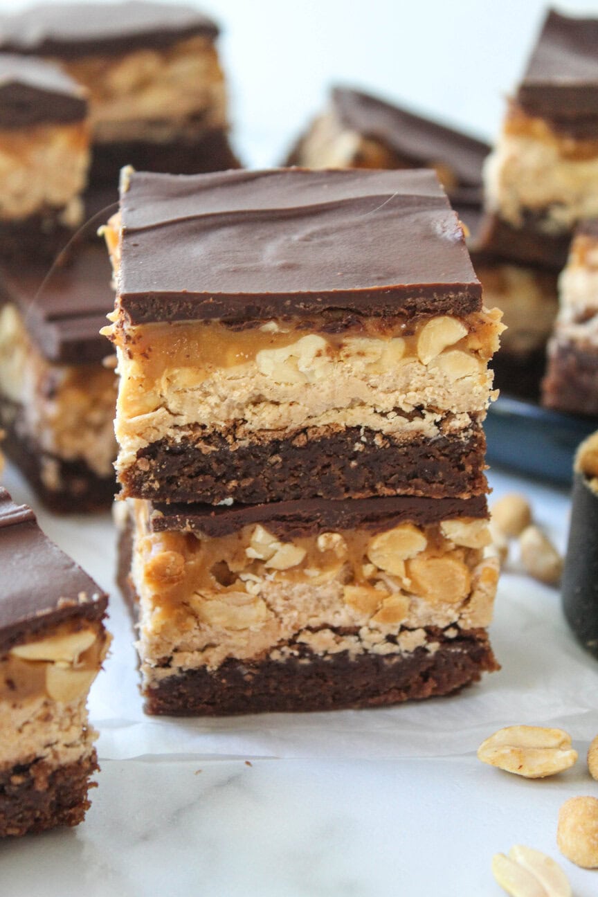 Fudgy chocolate brownies topped with nougat, peanuts, and glossy chocolate