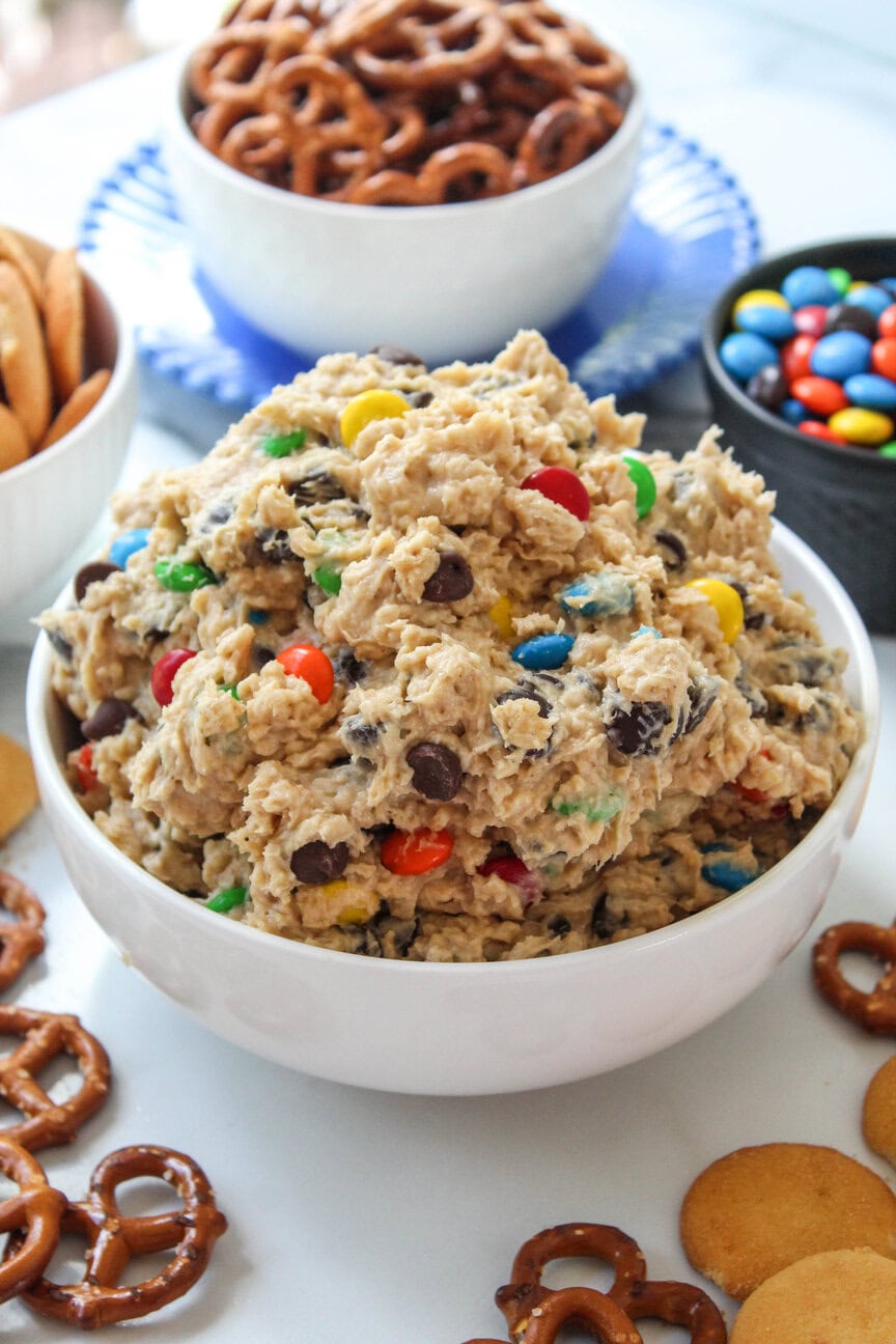 Creamy monster cookie dough dip topped with chocolate chips and colorful M&Ms
